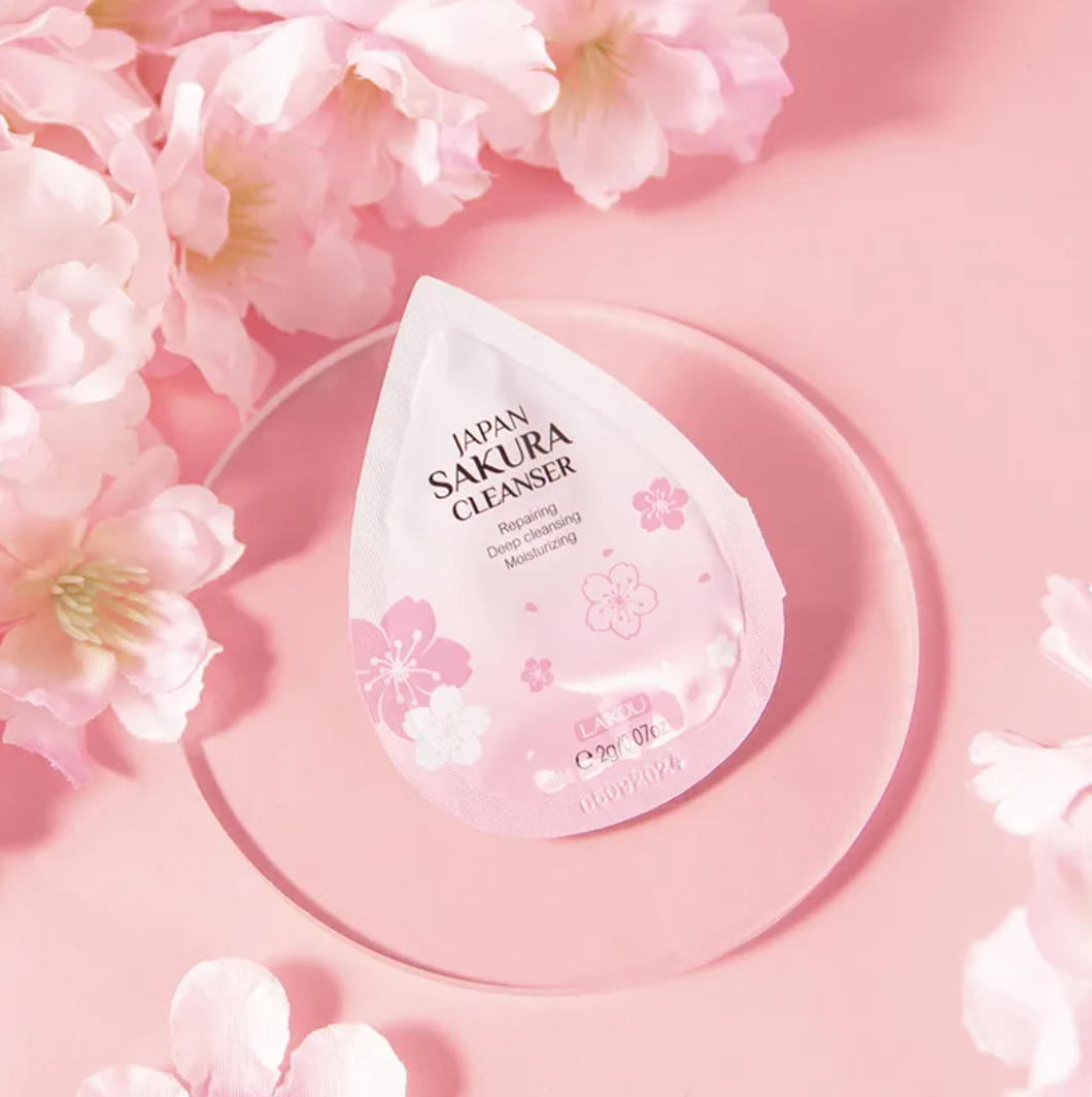 Japan Sakura Cleanser packaging with cherry blossoms on a pink background