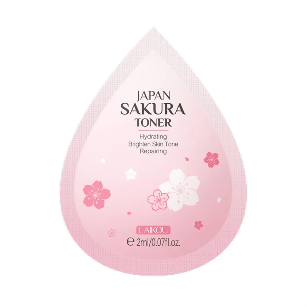 Pink droplet-shaped container of Japan Sakura Toner with cherry blossom designs on a white background