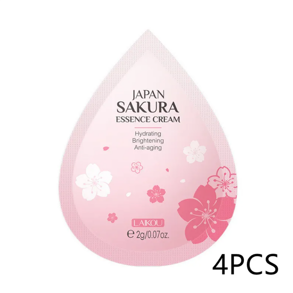 Pink essence cream packaging with cherry blossom design on a white background