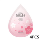 Pink essence cream packaging with cherry blossom design on a white background