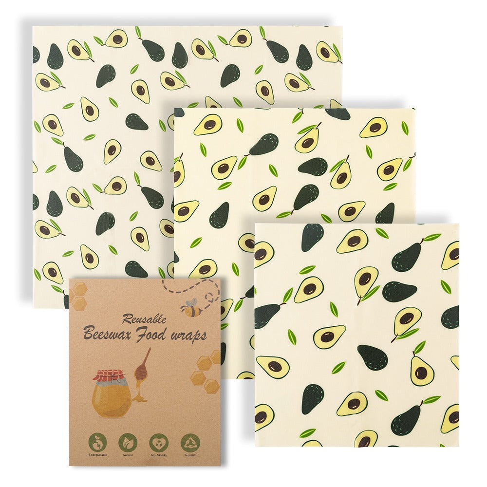 Set of reusable beeswax food wraps with avocado pattern on a white background