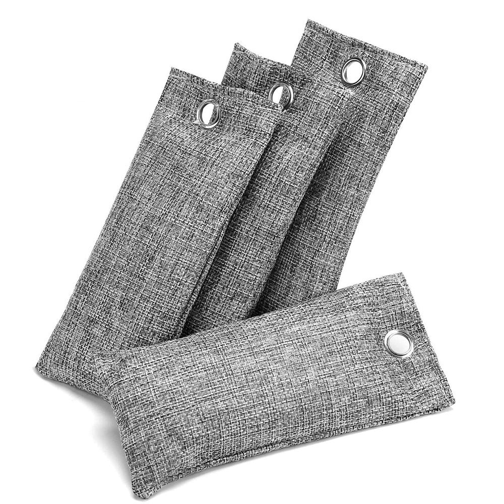 Four gray fabric air freshener pads with eyelets on a white background