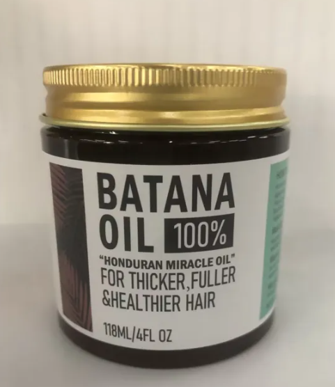 Jar of Batana Oil with a gold lid on a white background