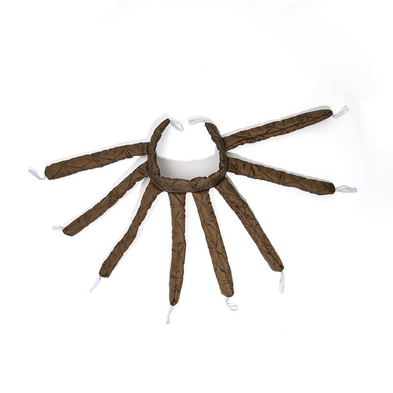 Spider-shaped toy with brown legs and white body on a white background