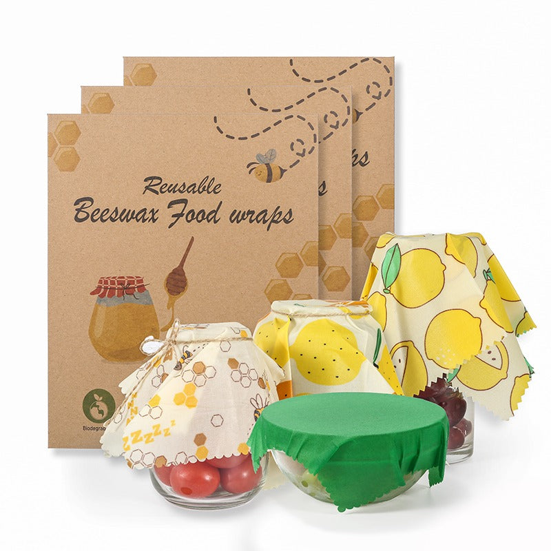 Reusable beeswax food wraps with packaging on a white background