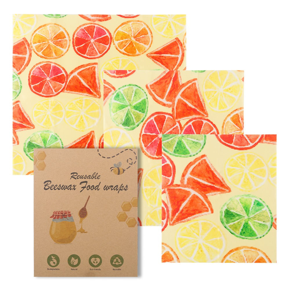 Reusable beeswax food wraps with citrus pattern and packaging on a white background