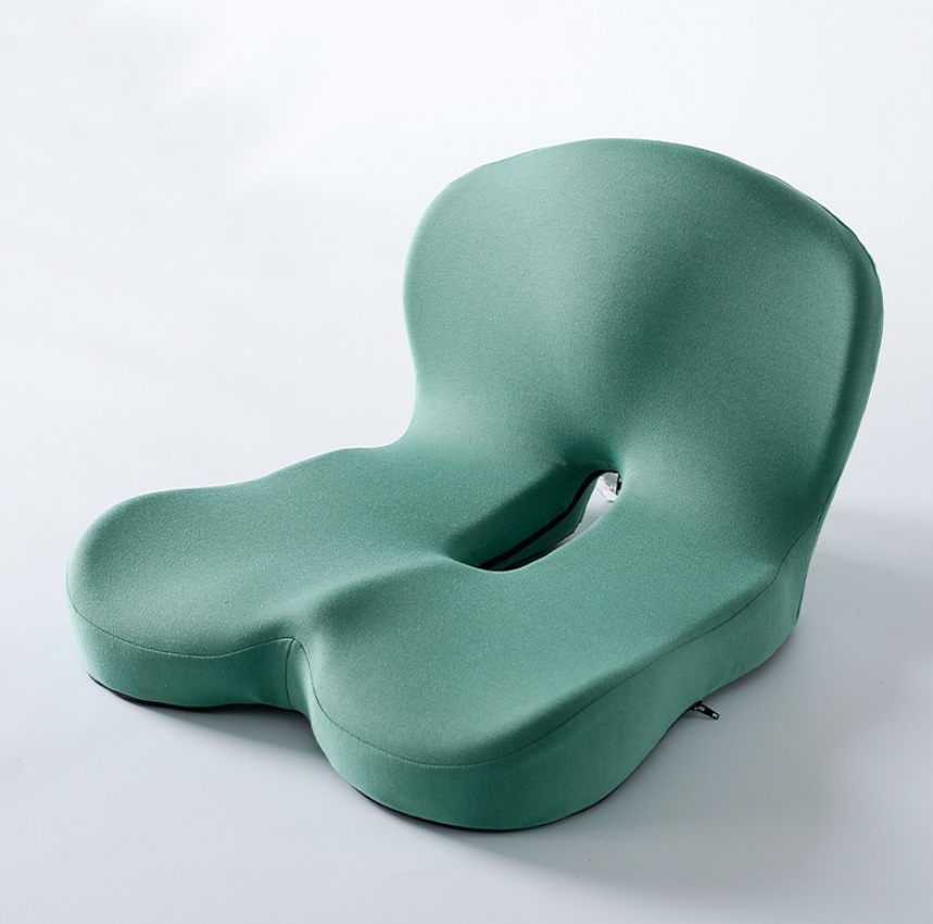 Green cushion with unique design on a white background