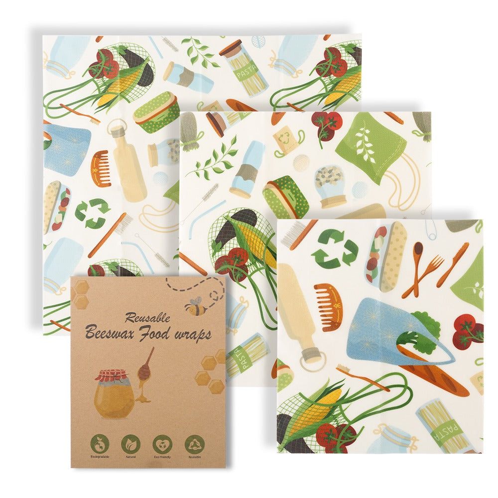 Beeswax food wraps with colorful patterns and a cardboard packaging on a white background