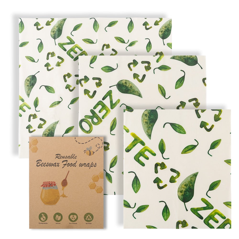 Set of reusable bee wax food wraps with green leaf pattern and 'Zero' text on a white background.