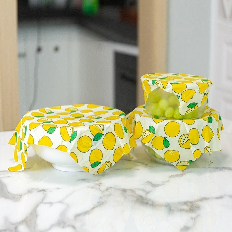 Reusable food wraps with lemon pattern on a marble surface