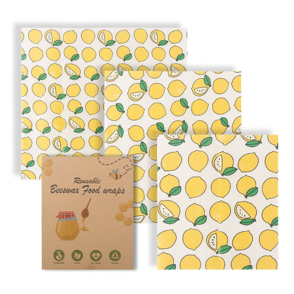 Set of reusable bee wax food wraps with lemon pattern on a white background