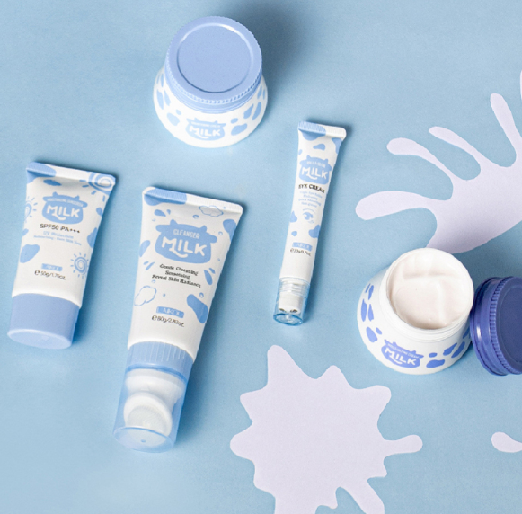 Collection of milk-themed skincare products on a light blue background