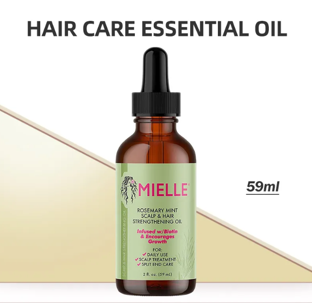 Hair care essential oil bottle with dropper labeled 'Mielle' on a beige background