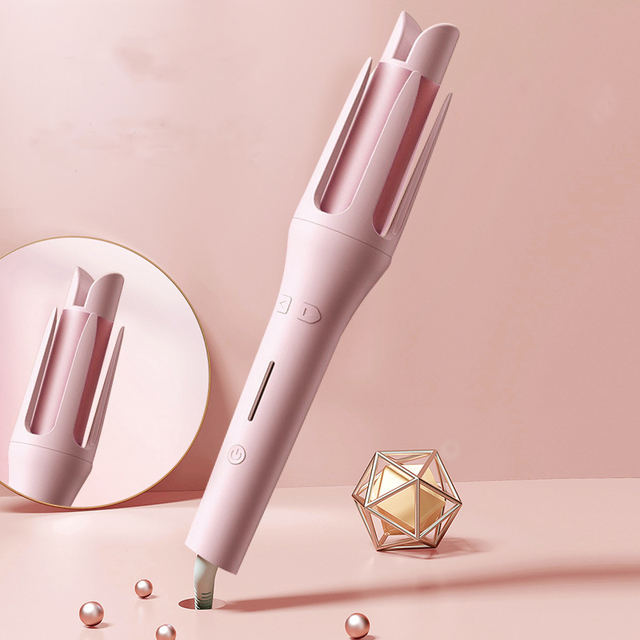 Pink hair styling tool on a pink background with decorative elements