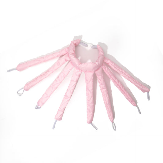 Pink shoe trees with multiple legs on a white background