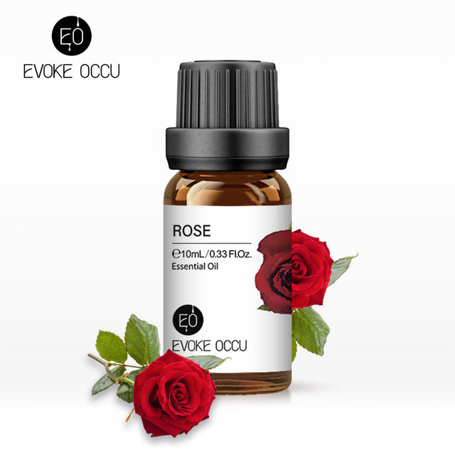 Rose essential oil bottle with red roses on a white background, featuring Evoke Occu branding.