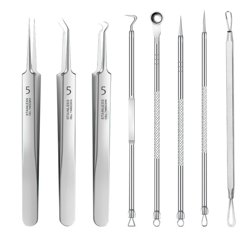 Set of stainless steel facial tools on a white background