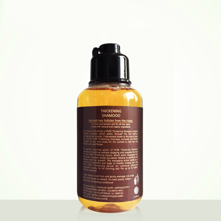 Bottle of thickening shampoo with yellow label on a white background